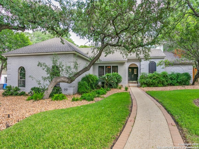 13907 Bluffmont, San Antonio, TX 78216 - view of front of property with brick siding, a shingled roof, and a front yard