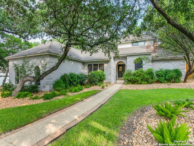 13907 Bluffmont, San Antonio, TX 78216 - view of front of house with a shingled roof, a front lawn, and brick siding