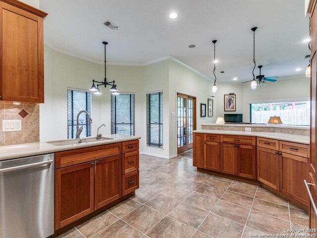 13907 Bluffmont, San Antonio, TX 78216 - kitchen featuring a sink, dishwasher, brown cabinetry, ceiling fan with notable chandelier, and a peninsula