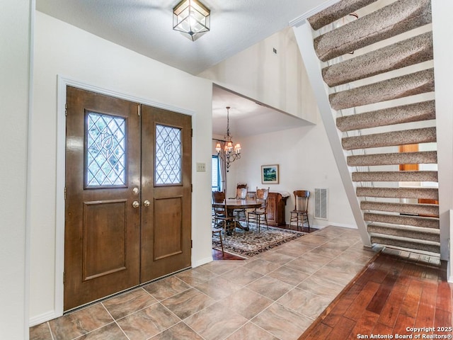 13907 Bluffmont, San Antonio, TX 78216 - entryway with baseboards, a notable chandelier, visible vents, and a towering ceiling