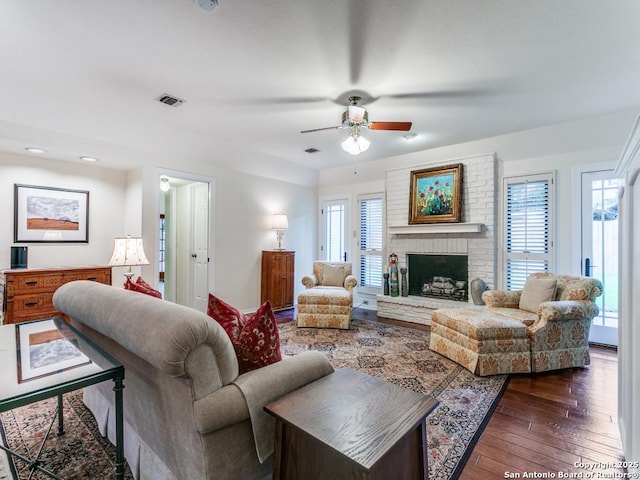 13907 Bluffmont, San Antonio, TX 78216 - living area featuring wood-type flooring, a ceiling fan, visible vents, and a fireplace
