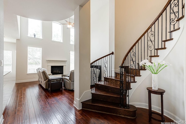 2623 Galit Cv, San Antonio, TX 78230 - stairs with baseboards, a high ceiling, a wealth of natural light, and hardwood / wood-style flooring