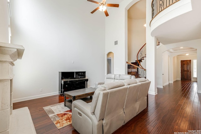 2623 Galit Cv, San Antonio, TX 78230 - living area with arched walkways, stairs, a towering ceiling, and ceiling fan
