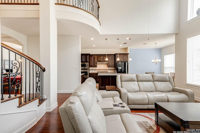 2623 Galit Cv, San Antonio, TX 78230 - living room with an inviting chandelier, dark wood-style flooring, stairs, baseboards, and recessed lighting
