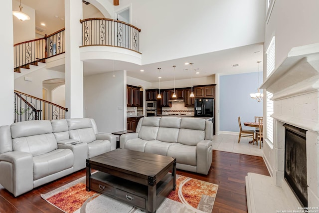 2623 Galit Cv, San Antonio, TX 78230 - living room with a high ceiling, stairs, a chandelier, and dark wood-type flooring
