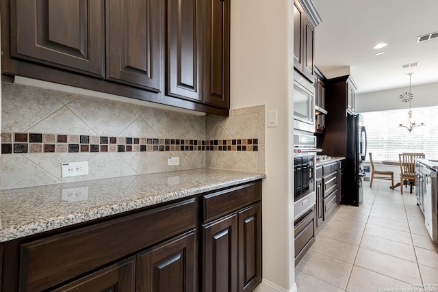 2623 Galit Cv, San Antonio, TX 78230 - kitchen featuring light tile patterned floors, dark brown cabinetry, and visible vents