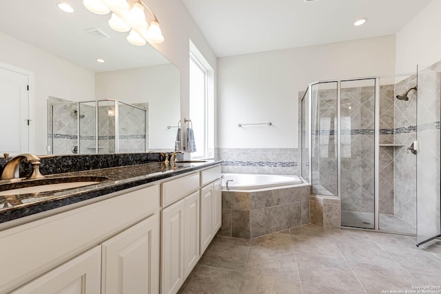 2623 Galit Cv, San Antonio, TX 78230 - bathroom with double vanity, a bath, visible vents, a stall shower, and a sink