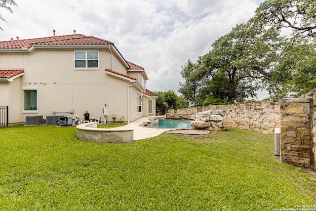 2623 Galit Cv, San Antonio, TX 78230 - back of property with central air condition unit, a fenced in pool, a lawn, a patio, and a tiled roof