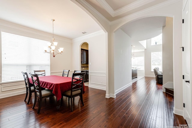 2623 Galit Cv, San Antonio, TX 78230 - dining space featuring visible vents, crown molding, arched walkways, dark wood-style floors, and a chandelier