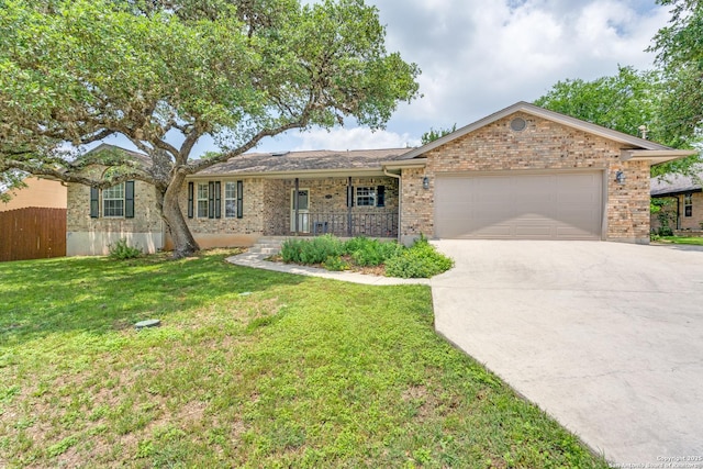 single story home featuring a garage, a front lawn, covered porch, brick siding, and driveway