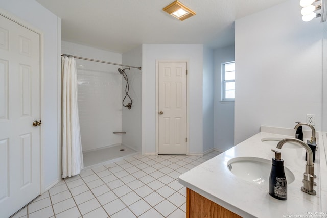full bath featuring double vanity, tile patterned floors, curtained shower, and a sink