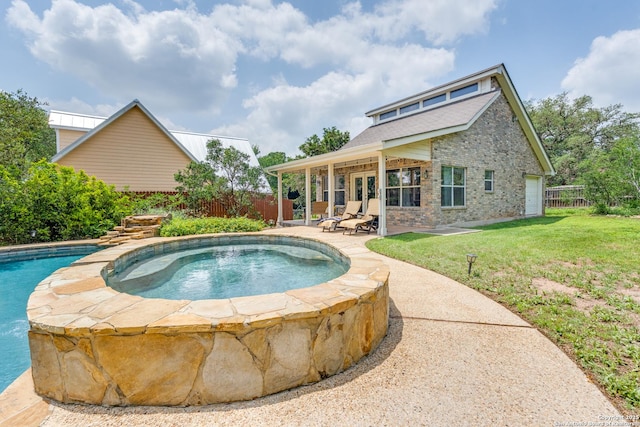 view of pool with an in ground hot tub, french doors, a lawn, a patio area, and a fenced backyard