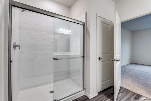 5014 Jovian, San Antonio, TX 78245 - full bathroom featuring baseboards, wood finished floors, and a stall shower