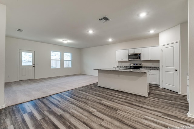5014 Jovian, San Antonio, TX 78245 - kitchen with dark wood-style flooring, stainless steel appliances, open floor plan, recessed lighting, and visible vents