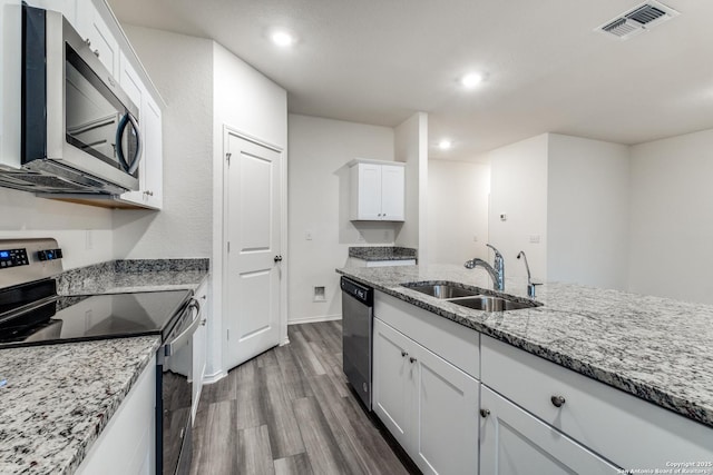 5014 Jovian, San Antonio, TX 78245 - kitchen featuring white cabinets, appliances with stainless steel finishes, a sink, dark wood-type flooring, and visible vents