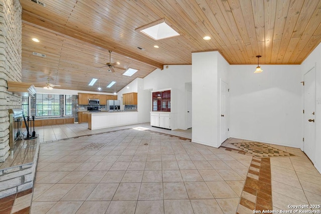 unfurnished living room featuring wood ceiling, ceiling fan, visible vents, baseboards, and light tile patterned flooring
