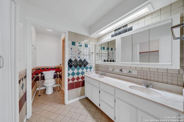 full bath with a sink, tile walls, tile patterned floors, and double vanity