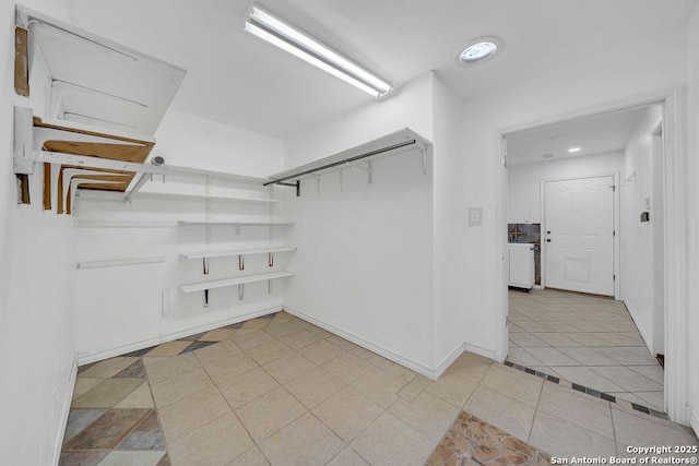 spacious closet with light tile patterned flooring