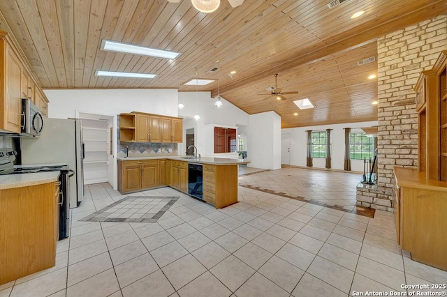 kitchen featuring open shelves, black appliances, a peninsula, lofted ceiling with skylight, and open floor plan