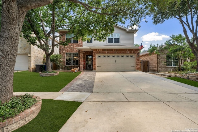 traditional-style house with an attached garage, a front yard, driveway, and brick siding