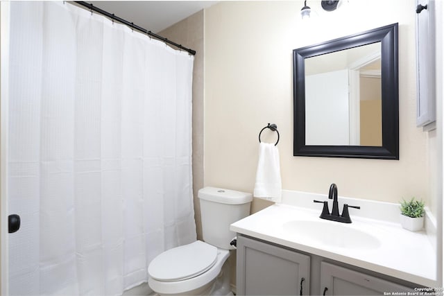 bathroom featuring vanity, toilet, and a shower with curtain