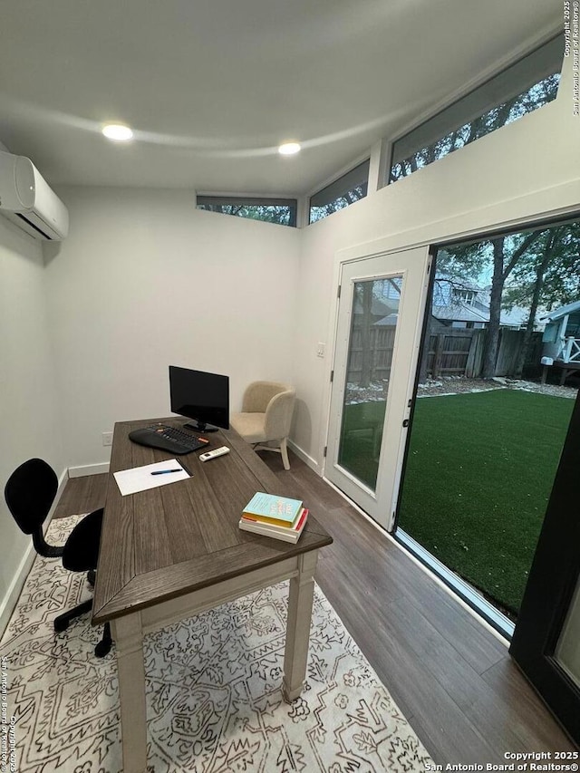 office area with baseboards, an AC wall unit, recessed lighting, and wood finished floors