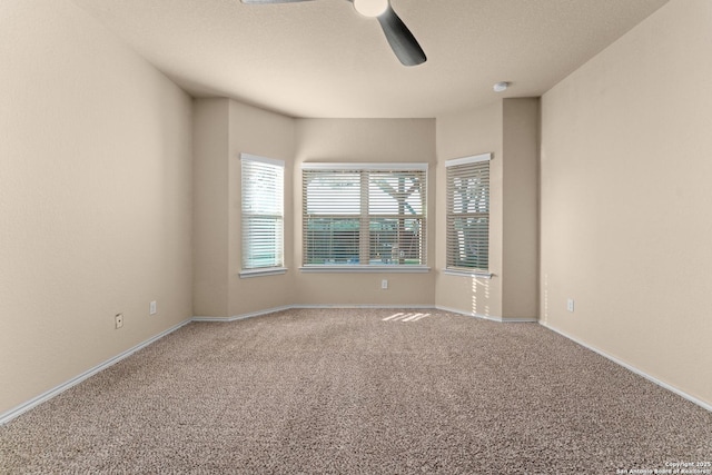 unfurnished room with baseboards, carpet, and a ceiling fan