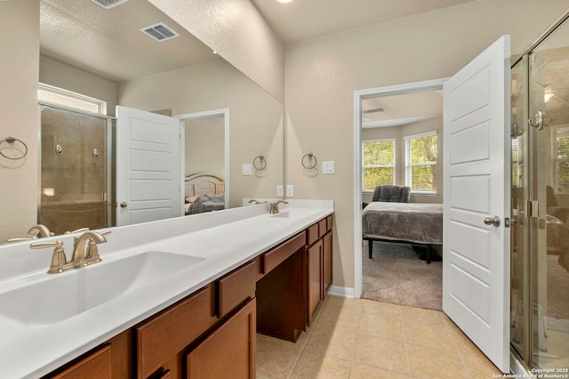 205 Wickersham, Boerne, TX 78015 - full bath with visible vents, double vanity, connected bathroom, a shower stall, and a sink