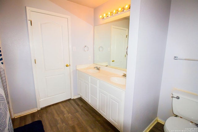 5315 Argyle, San Antonio, TX 78247 - full bathroom with a sink, double vanity, toilet, baseboards, and wood finished floors