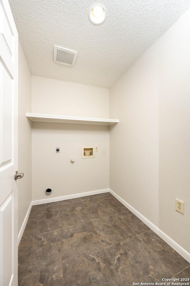 washroom with washer hookup, hookup for an electric dryer, laundry area, a textured ceiling, and visible vents