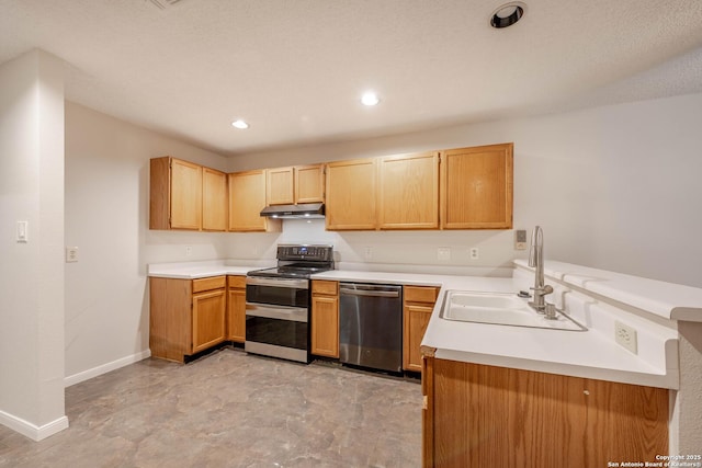 kitchen featuring baseboards, light countertops, under cabinet range hood, a sink, and stainless steel appliances