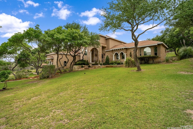 mediterranean / spanish-style home featuring stucco siding and a front lawn