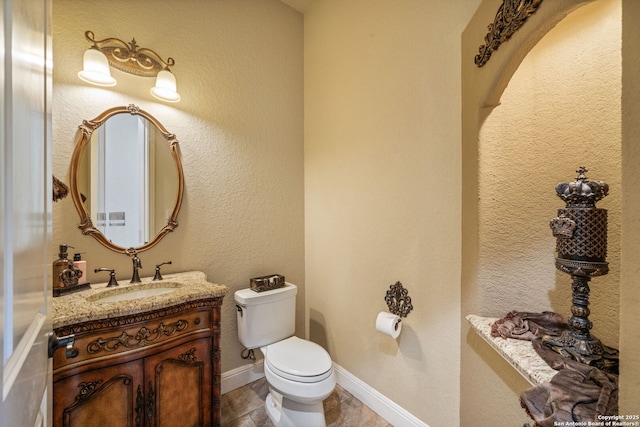 half bathroom featuring vanity and toilet