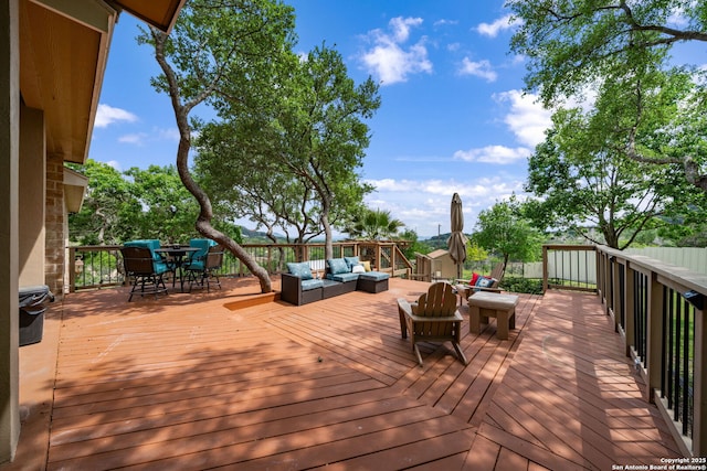 wooden terrace with an outdoor hangout area and outdoor dining space
