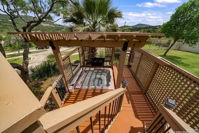 balcony featuring a deck with mountain view and stairway
