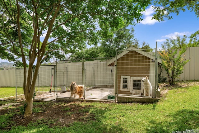 exterior space featuring fence, an outbuilding, and an exterior structure