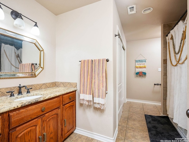 full bath featuring vanity, tile patterned flooring, baseboards, and visible vents