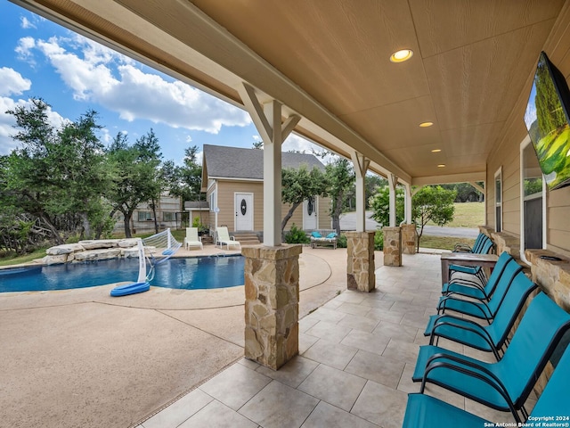 pool with an outbuilding and a patio