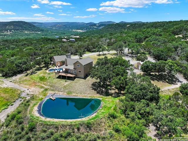 birds eye view of property featuring a view of trees and a mountain view