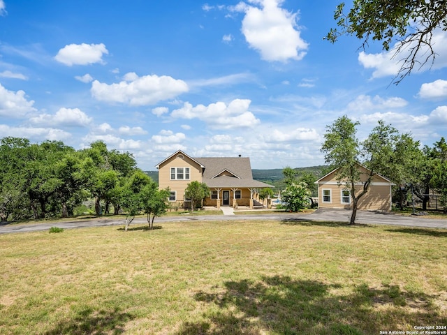 view of front facade featuring a porch, aphalt driveway, and a front yard