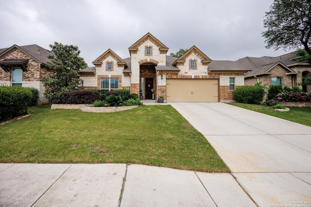 view of front of house with stone siding, an attached garage, driveway, and a front yard