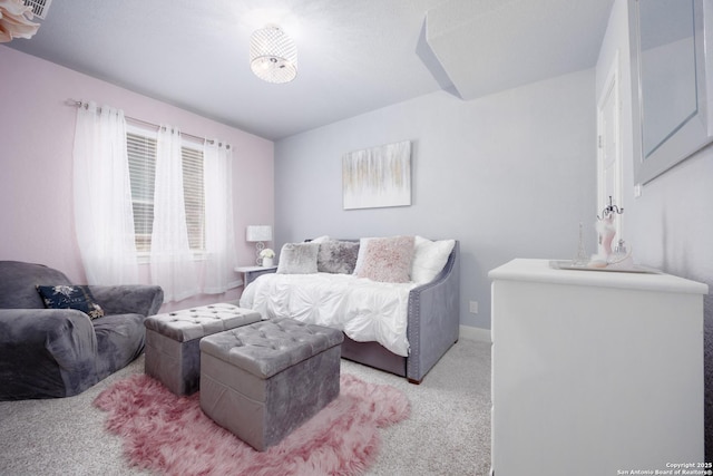 living area with baseboards and light colored carpet
