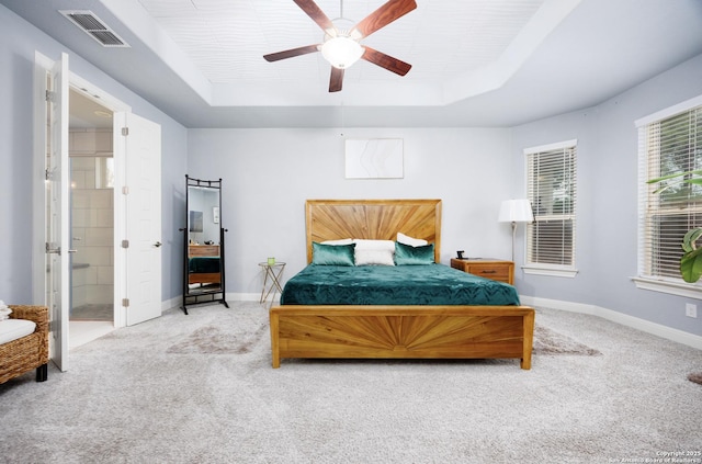 bedroom with a raised ceiling, baseboards, carpet flooring, and visible vents