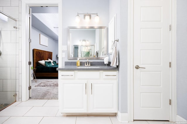 full bathroom featuring vanity, connected bathroom, tile patterned floors, and tiled shower