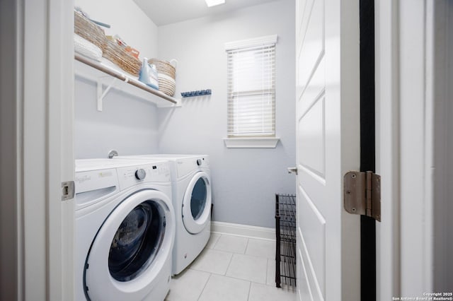 laundry area featuring light tile patterned floors, baseboards, laundry area, and independent washer and dryer