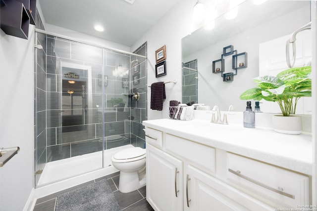 bathroom featuring recessed lighting, vanity, a shower stall, and toilet