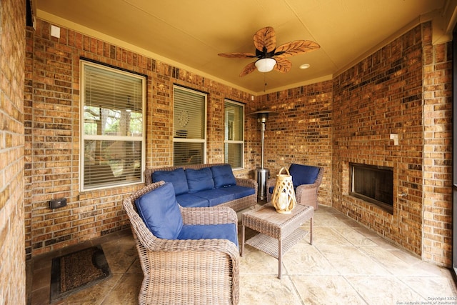 view of patio / terrace with an outdoor living space with a fireplace and ceiling fan