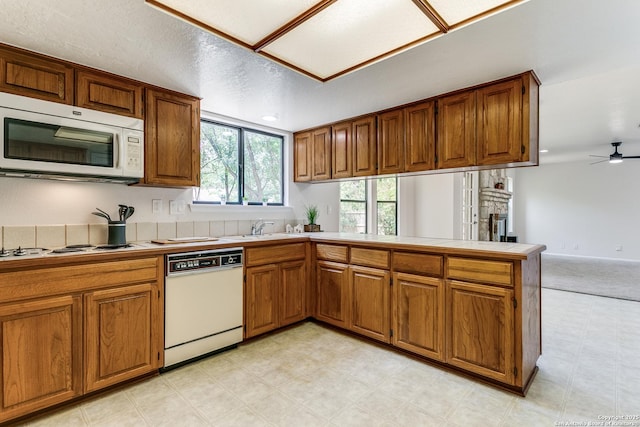 19750 Encino Way, San Antonio, TX 78259 - kitchen featuring white appliances, a peninsula, light floors, and brown cabinetry
