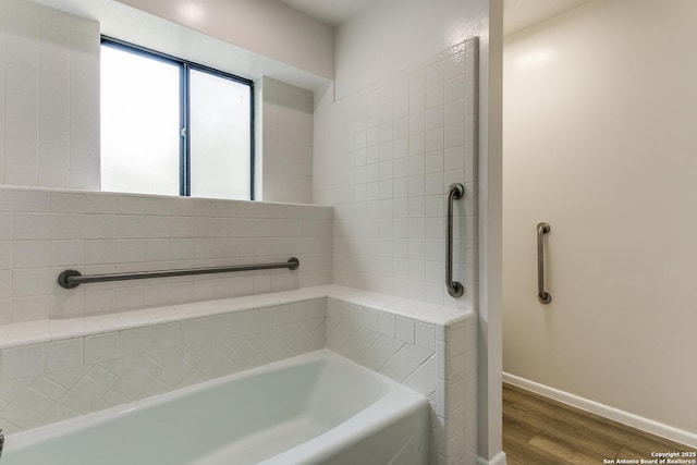 19750 Encino Way, San Antonio, TX 78259 - bathroom with wood finished floors, a tub, and baseboards
