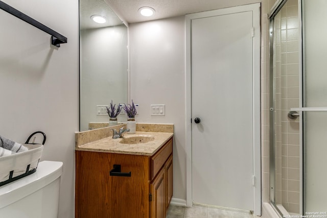 19750 Encino Way, San Antonio, TX 78259 - full bathroom featuring toilet, vanity, tiled shower, and a textured ceiling